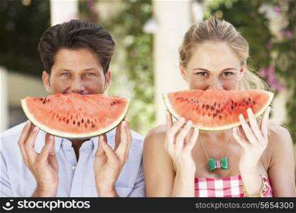 Couple Enjoying Slices Of Water Melon