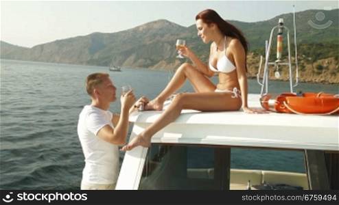 Couple Enjoying The Cruise on a Luxury Yacht with Champagne