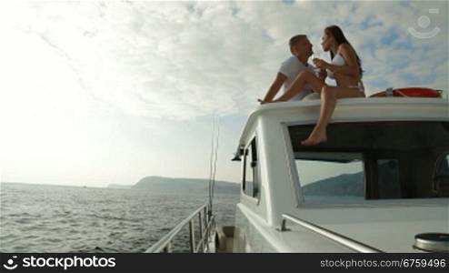 Couple Enjoying The Cruise on a Luxury Yacht with Champagne