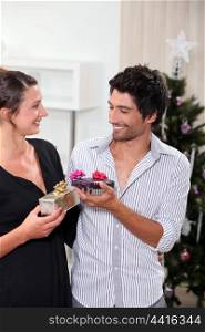 Couple exchanging Christmas gifts
