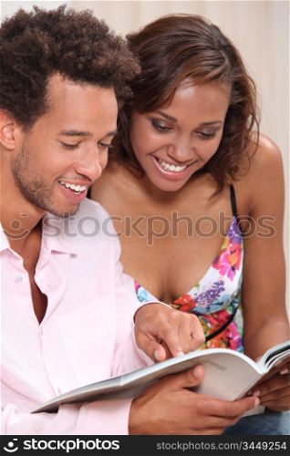 Couple excitedly looking at a catalogue