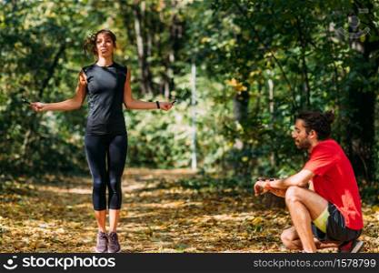 Couple Exercising in a Park. Friends Exercising Outdoors Together