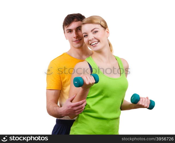 Couple exercising with dumbbells lifting weights . Couple fit woman and strong man exercising with dumbbells. Muscular guy and fitness blonde girl lifting weights. Bodybuilding.