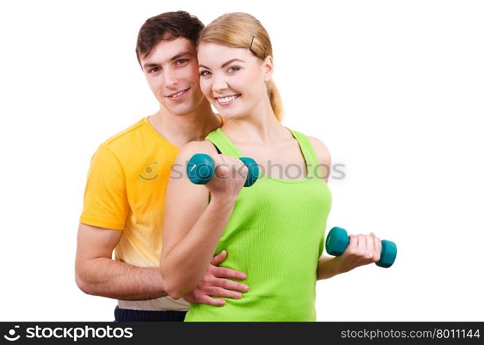 Couple exercising with dumbbells lifting weights . Couple fit woman and strong man exercising with dumbbells. Muscular guy and fitness blonde girl lifting weights. Bodybuilding.