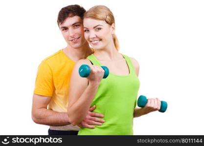 Couple exercising with dumbbells lifting weights . Couple fit woman and strong man exercising with dumbbells. Muscular guy and fitness blonde girl lifting weights. Bodybuilding.