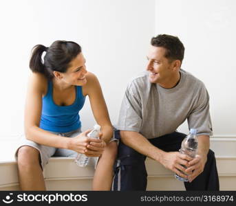 couple, eye contact, happy, portrait, smile, smiling, trainer, fit, physical, workout, fitness, health, gym, health club, hydration, bottle, bottled, water, break, sitting, wellness, recreation, l...