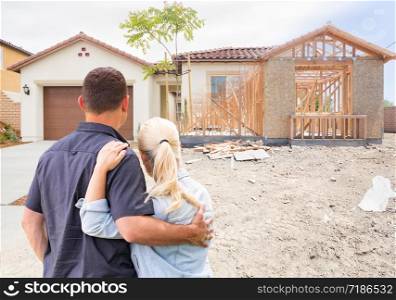 Couple Facing Construction Framing Gradating To Completed Home.