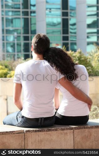 Couple facing office block