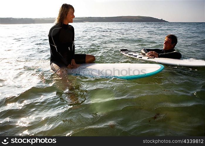 Couple floating on surfboards