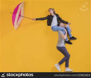 couple floating with umbrella