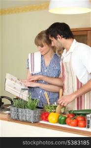 Couple following a recipe book