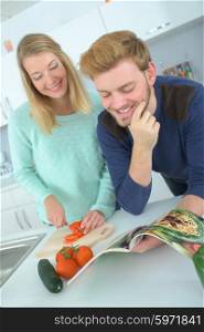 Couple following recipe from a magazine