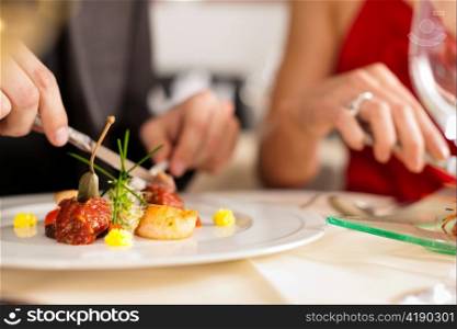 Couple for romantic Dinner or lunch in a gourmet restaurant drinking wine and eating