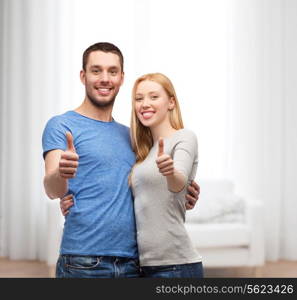 couple, gesture and family concept - smiling couple showing thumbs up