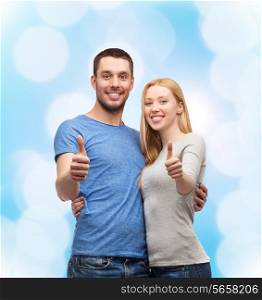 couple, gesture and family concept - smiling couple showing thumbs up
