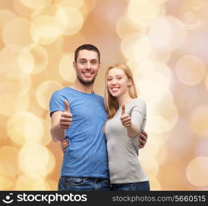 couple, gesture and family concept - smiling couple showing thumbs up