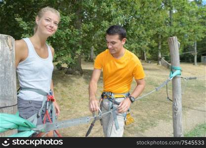 couple getting ready for the rope park