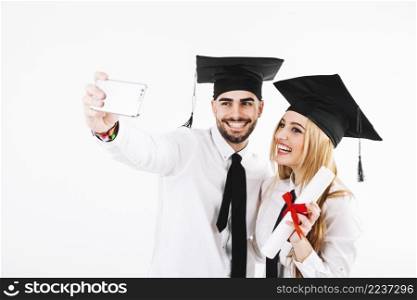 couple graduating taking selfie