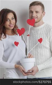 Couple grow tree of love. Happy couple growing tree of love, Valentines day wedding concept