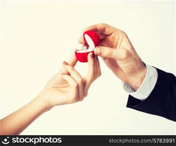 couple hands with wedding ring and gift box.