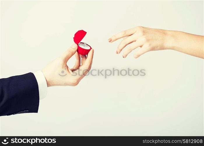 couple hands with wedding ring and gift box.