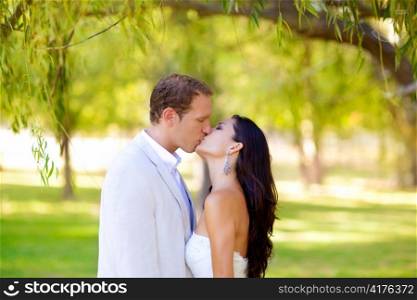 couple happy in love kissing in the park under the trees