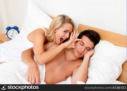 couple has fun in bed. laughter, joy and eroticism in the bedroom