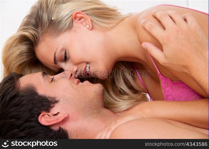 couple has fun in bed. laughter, joy and eroticism in the bedroom