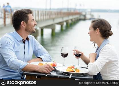 couple having a date at the restaurant overlooking a bridge