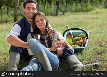 Couple having a picnic in a vineyard
