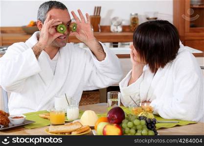 Couple having breakfast in bathrobe