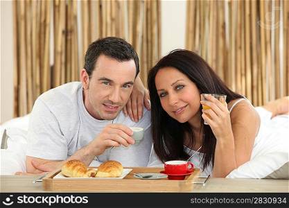 couple having breakfast in bed