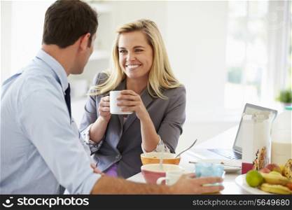 Couple Having Breakfast Together Before Leaving For Work