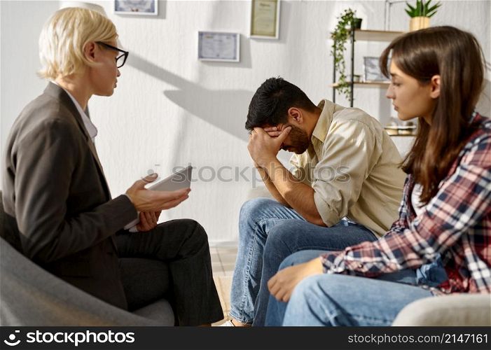 Couple having emotional speech explaining something to each other. Therapy session. Couple having emotional speech during therapy session