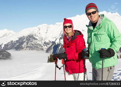 Couple Having Fun On Ski Holiday In Mountains