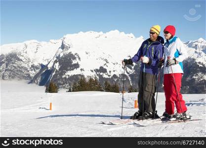 Couple Having Fun On Ski Holiday In Mountains