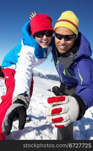 Couple Having Fun On Ski Holiday In Mountains