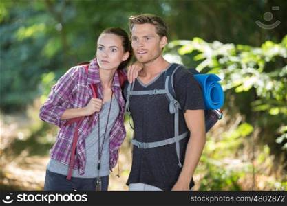 couple hiking and looking surprised