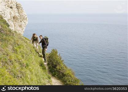 Couple Hiking on a Path Above the Water