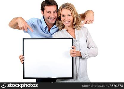 couple holding a frame