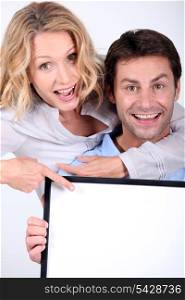 couple holding a frame