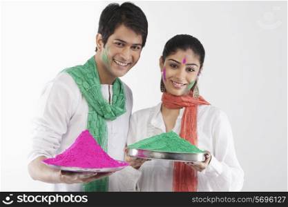 Couple holding a tray of colours