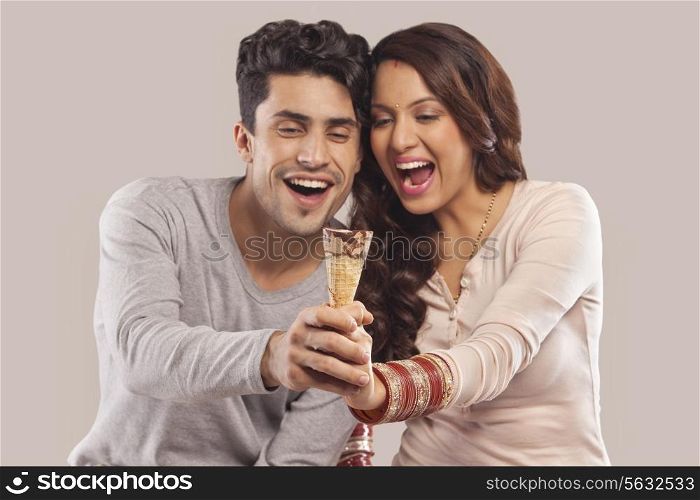Couple holding an ice cream cone