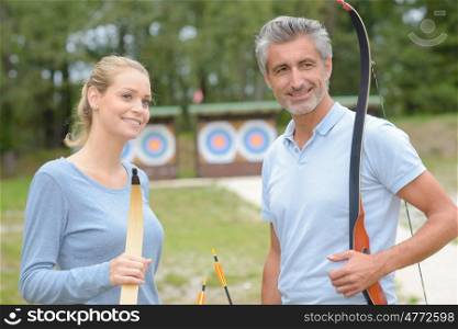 Couple holding bows and arrows