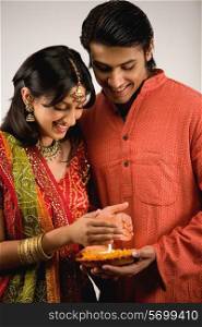 Couple holding Diya