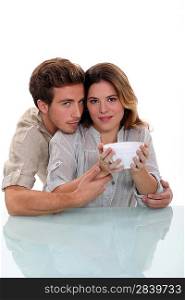Couple holding empty bowl
