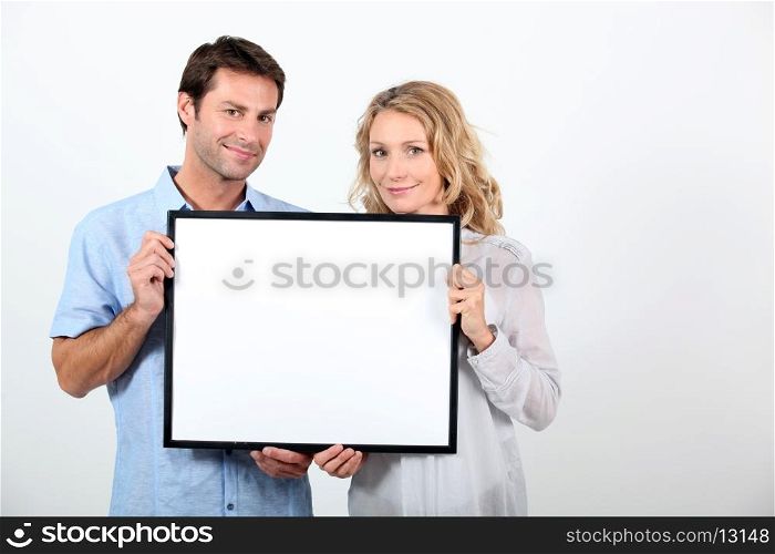 couple holding frame