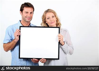 couple holding frame