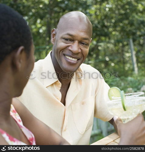 Couple holding glasses of cocktail