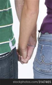 Couple holding hands against white background